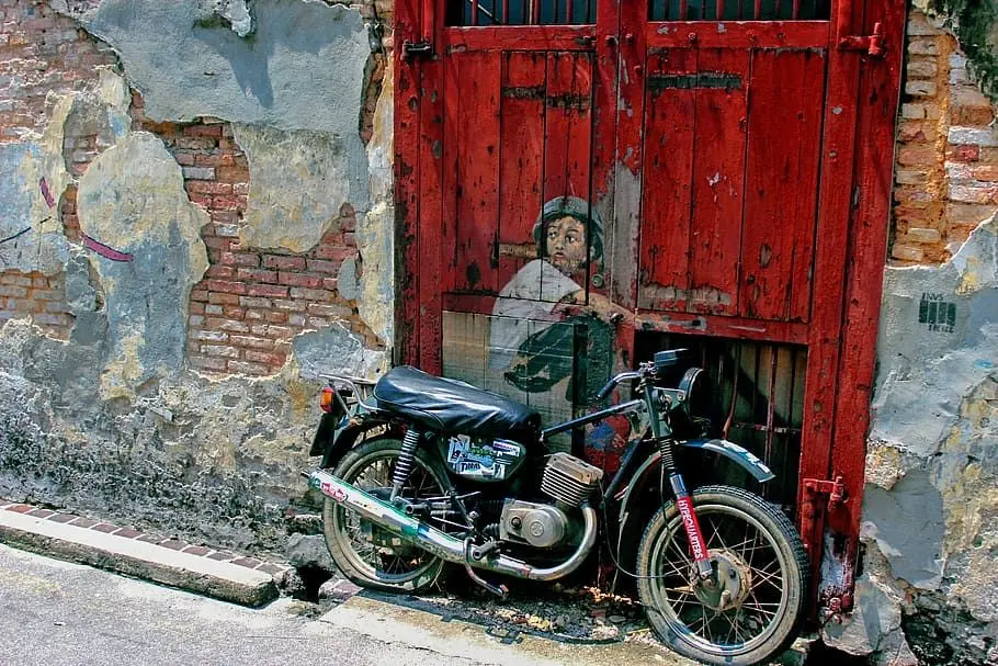 Boy on Motorbike Street Art - Street Art in George Town
