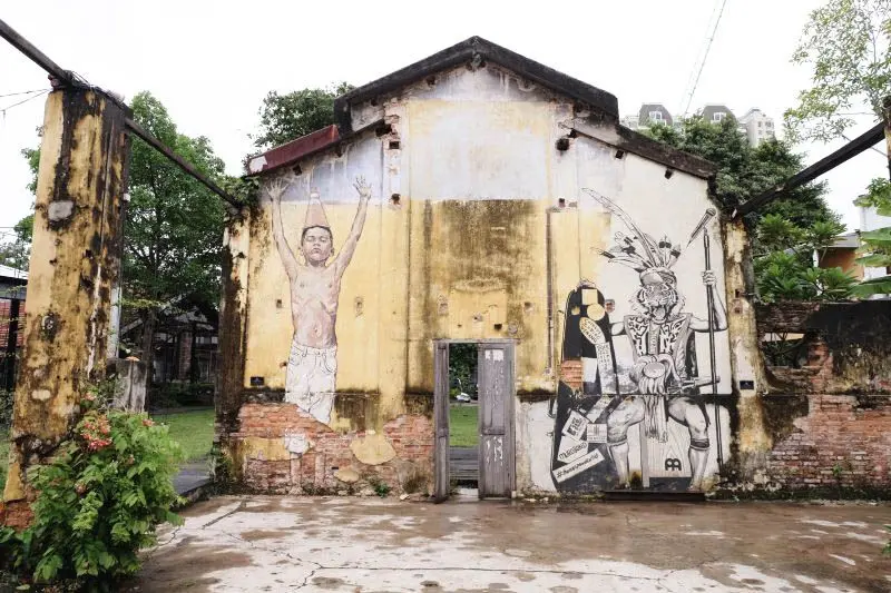 The Borneo Headhunter with the Head of Tiger Street Art - Street Art in George Town
